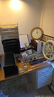 Overall view of desk with drafting tools, letter trays, bill organizer, calculator