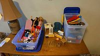 Two plastic bins showing entire mixed toy lot