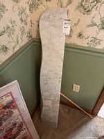 Front view of one marble shelf showing curved S-profile and veining