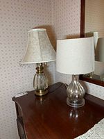 Both table lamps with shades on dresser