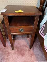 Front view of nightstand showing shelf, dovetailed drawer, legs and hardware