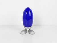 Full view of lamp unlit showing blue glass shade and silver base