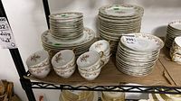 Full lot on shelf showing stacks of plates and cups