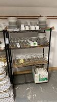 Front view of black steel wire shelving unit with four shelves
