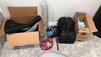 Group shot of all items including bed in box, harness, leashes, bag, mat, bowl
