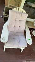 Front view showing white Adirondack rocker with mauve-pink cushion