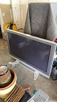 Front view of Panasonic 50-inch plasma TV standing on pedestal in garage