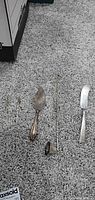 All four sterling utensils laid out on carpet