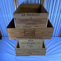 Stack of four wooden wine crates showing branding