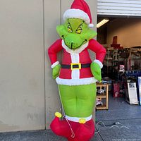 Full view of inflated Grinch standing outside