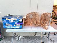 Box showing product details and both grapevine deer figures on table