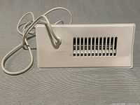 Front view showing grille and attached power cord