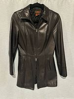 Full view of front showing leather finish, double zipper, pockets