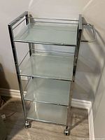 Full view of cart front showing shelves, frame and casters