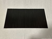 Full view of flat black bamboo slatted tray