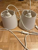 Both pendant lamps showing shades, sockets, cords, inline switch and plug