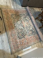 Rug partially unrolled showing full width and pattern