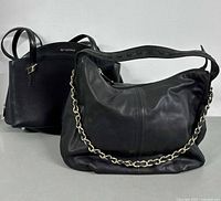 Two black leather handbags, Cromia structured satchel and Danier hobo