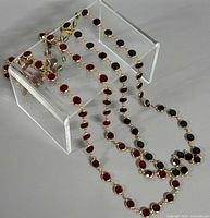 Both necklaces draped to show alternating bezel-set crystals and gold-tone links