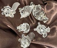 Group shot of all six crystal animal figurines on satin fabric
