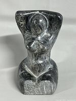 Front view of stone female torso carving