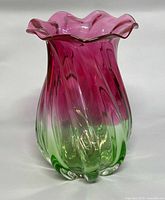 Front view showing pink-to-green gradient, twisted ribs, ruffled rim