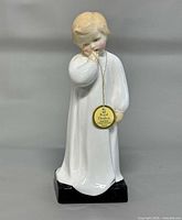 Full front view of figurine showing height and tag