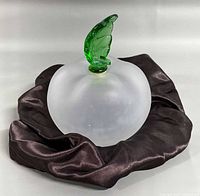 Full view of bottle resting on fabric