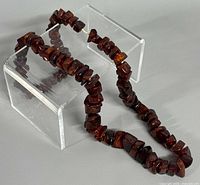 Necklace laid out showing irregular graduated amber beads