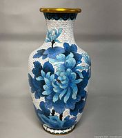 Front view of white cloisonné vase with blue chrysanthemums and gold rim