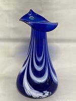 Full view of cobalt blue art glass vase showing height and swirl design