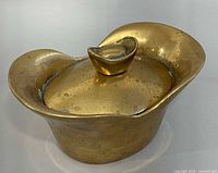 Brass container with lid in place, showing overall shape