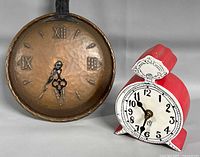 Both clocks side by side showing overall forms and faces