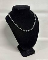 Necklace displayed on bust form showing full strand