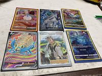 All six sleeved Pokémon cards laid out face-up