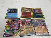 Overview of six Pokémon cards laid out on table