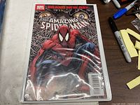 Front view of bagged The Amazing Spider-Man Brand New Day comic on table
