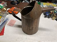 Full view of copper pitcher showing handle and spout