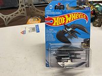 Front view of sealed Hot Wheels Batplane blister pack on table