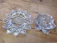 Top view showing both crystal lotus candle holders, illustrating size difference and clear faceted design