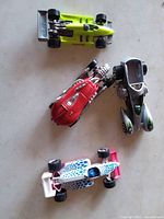 Top view of four Hot Wheels cars showing colors and styles
