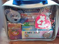 Front of sealed case showing bear, cards, coin