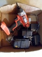 Box containing Black & Decker cordless drill, two 18V battery packs and charger