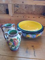 Falcon Ware bowl with yellow interior and two small floral vases