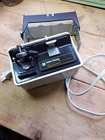 Overall view of Black & Decker Spacemaker under-cabinet electric can opener, mounting bracket and power cord visible