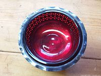 Top view showing red cranberry glass liner and scalloped silver rim