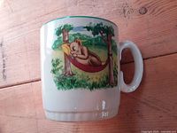 Front view of mug showing cat in hammock illustration