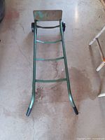Front angled view of green metal hand dolly
