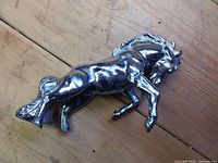 Side view of chrome horse hood ornament