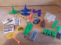 Entire lot showing plastic track parts, two cars, sign, cardboard panels